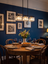 Fjord crystal pendant light glowing above a supper table in the evening