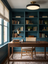 Halo ceiling light above a walnut desk in a teal study