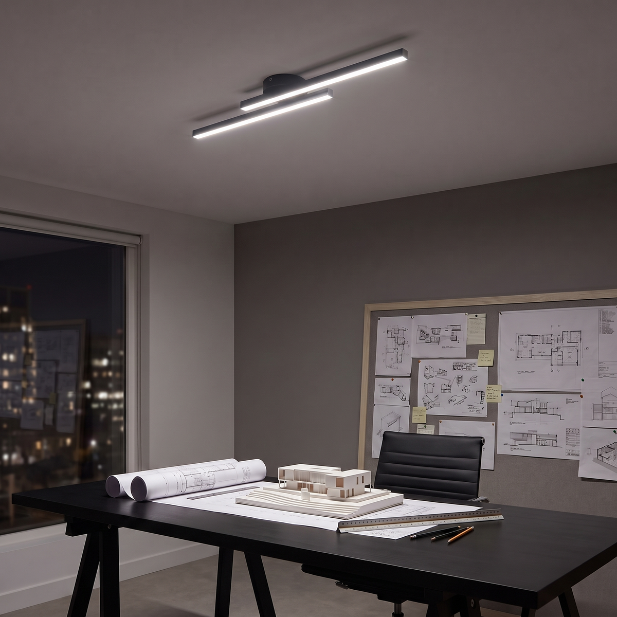 Linea linear LED ceiling light above an architect's desk at night