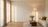 Warm living room at golden hour with an arched floor lamp beside a cream boucle sofa